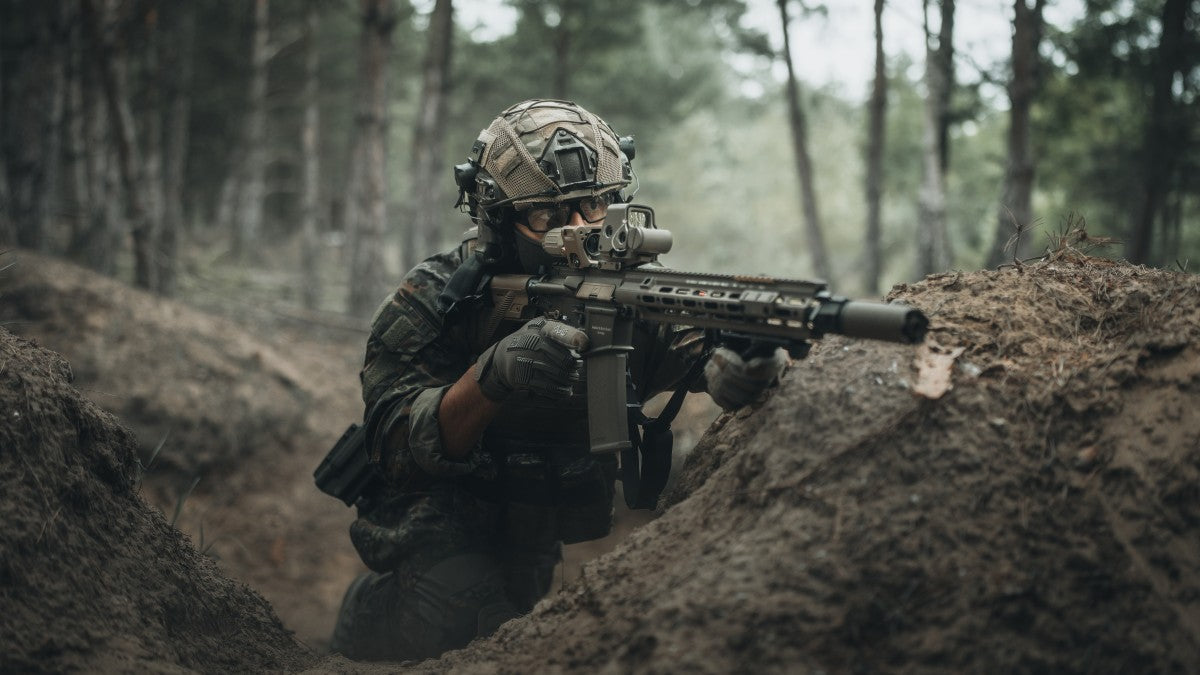 A soldier in battle holding strong and showing resilience.