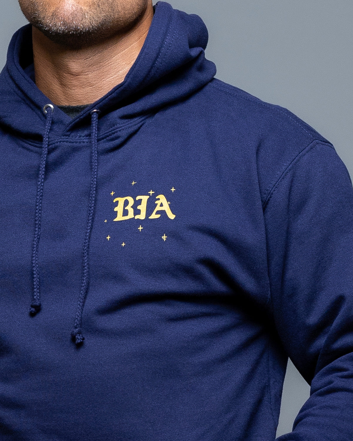 Navy blue hoodie with 'BIA' logo on a gray background. #color_navy