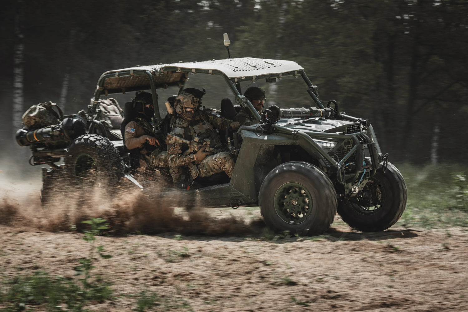 Unit of soldiers riding together in a military vehicle.