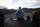 Person sitting on the back of a truck looking into the wilderness.