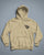 Beige hoodie with black text on a gray background - Acta Non Verba Hoodie