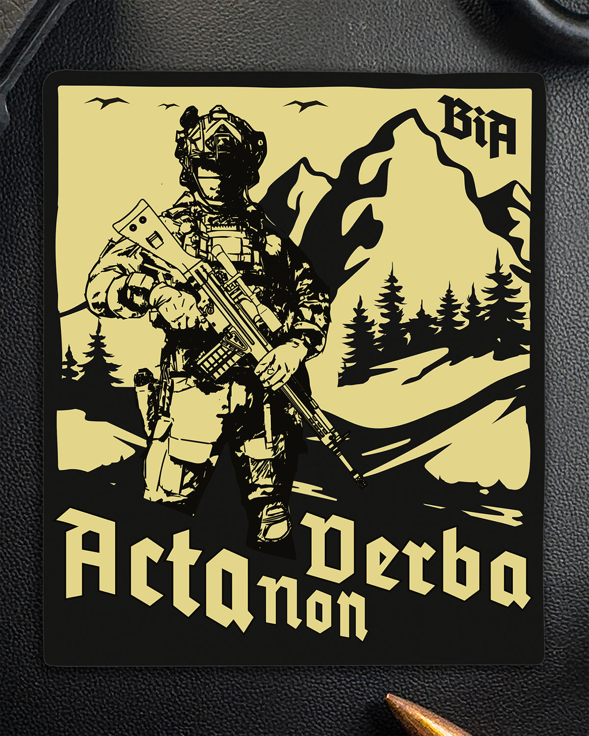 Single Acta Non Verba sticker with the soldier and mountain artwork on a dark surface