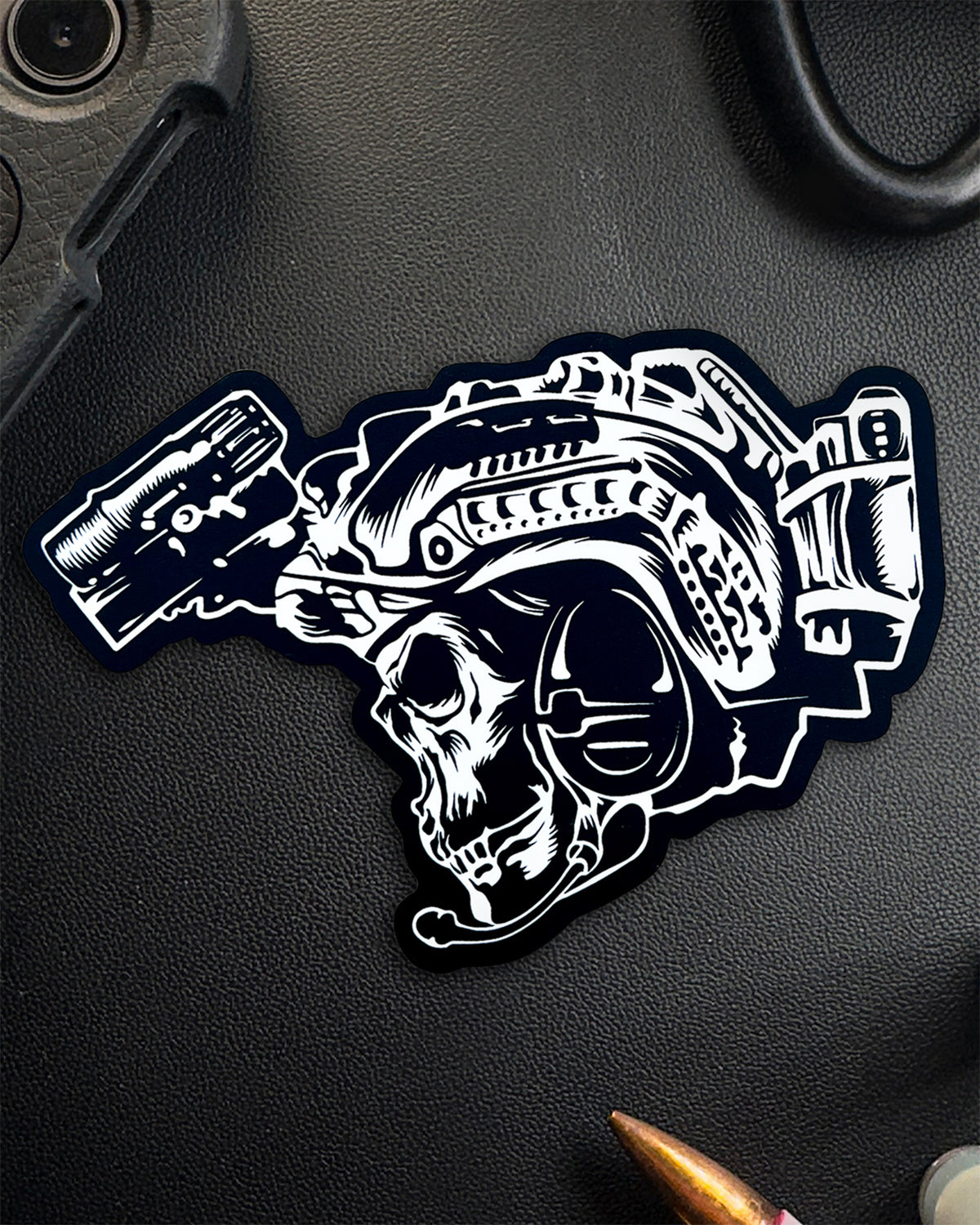 Single BIA sticker with skull, helmet and night vision on a dark surface