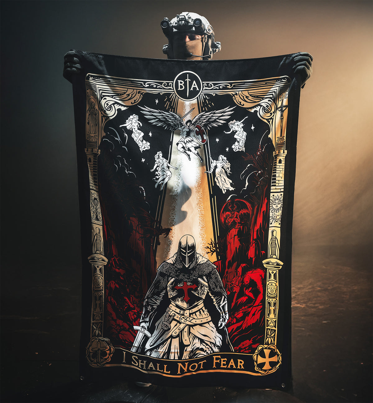 Person in a helmet holding up the I Shall Not Fear flag with the knight and angel artwork