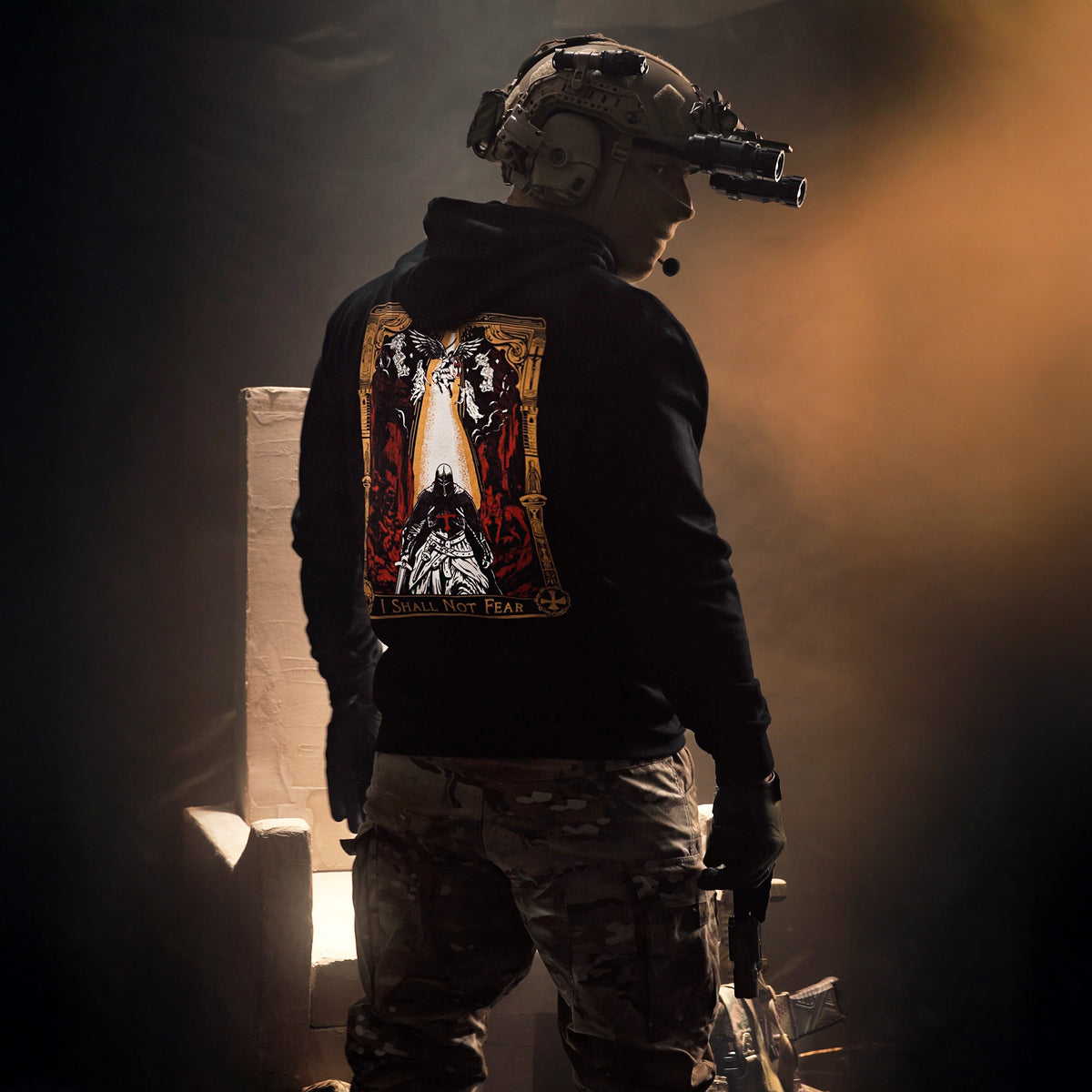 Person in tactical gear with a dark hooded jacket featuring a graphic design - No fear hoodie