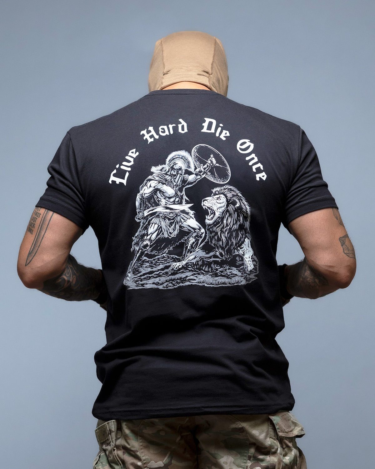 Man from behind in the black Live Hard Die Once T-Shirt with the reaper and lion back print