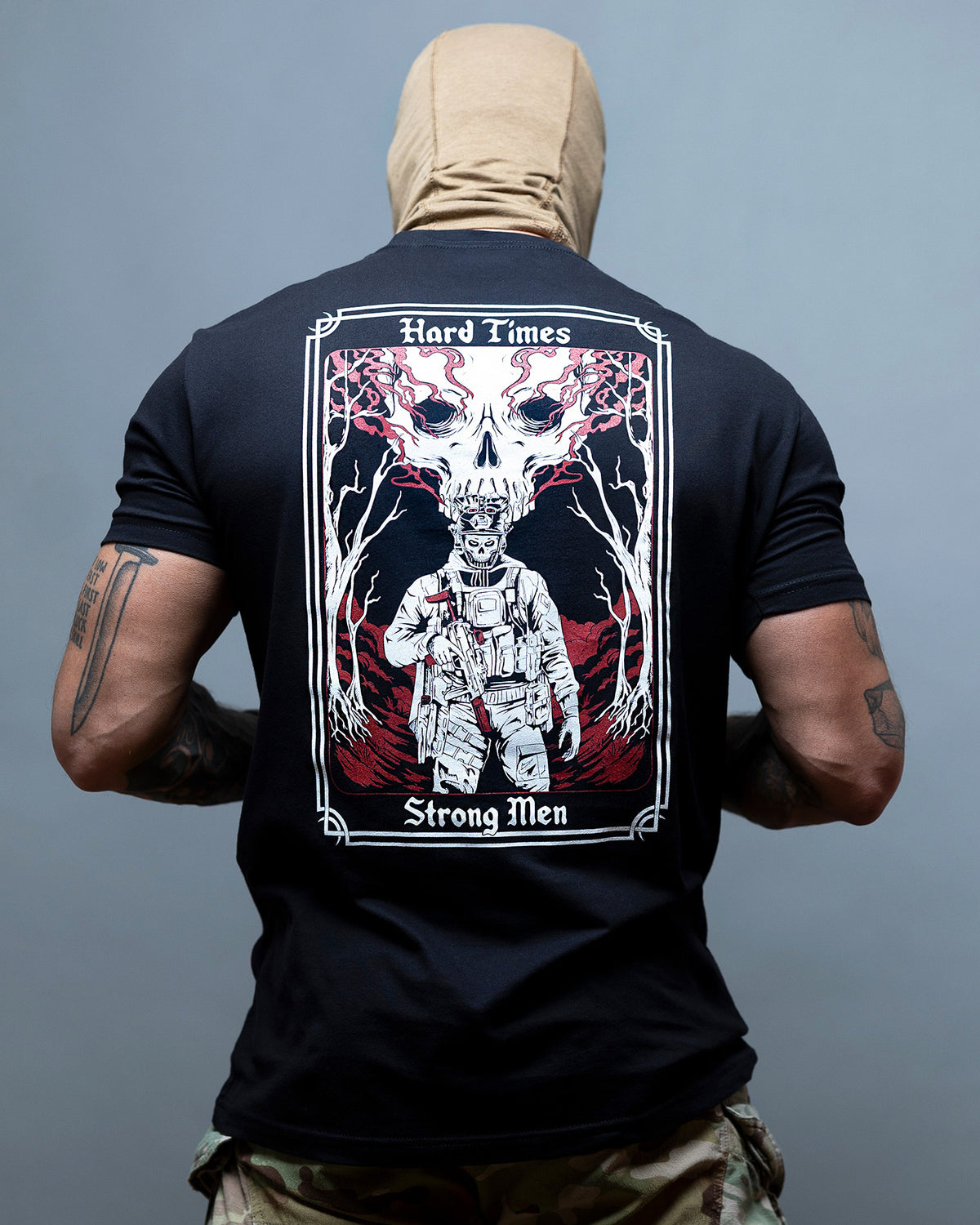 Man from behind in the black Hard Times T-Shirt with the tarot card back print