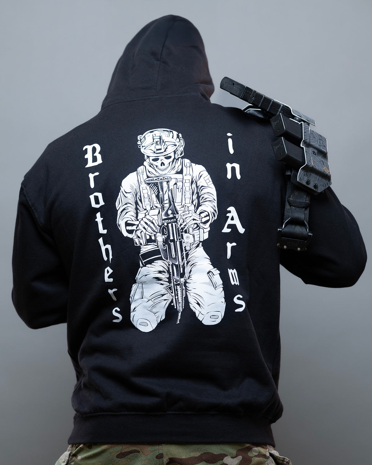 Man from behind in the black Brothers in Arms Hoodie with the vertical back lettering