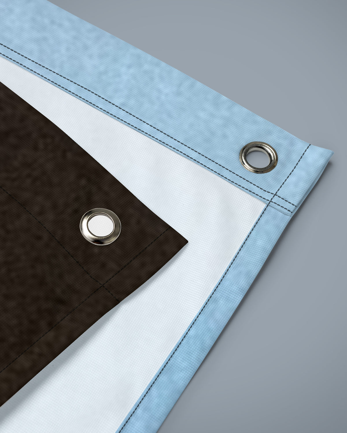 Corner of the It Is What It Is flag with reinforced edge and metal eyelet