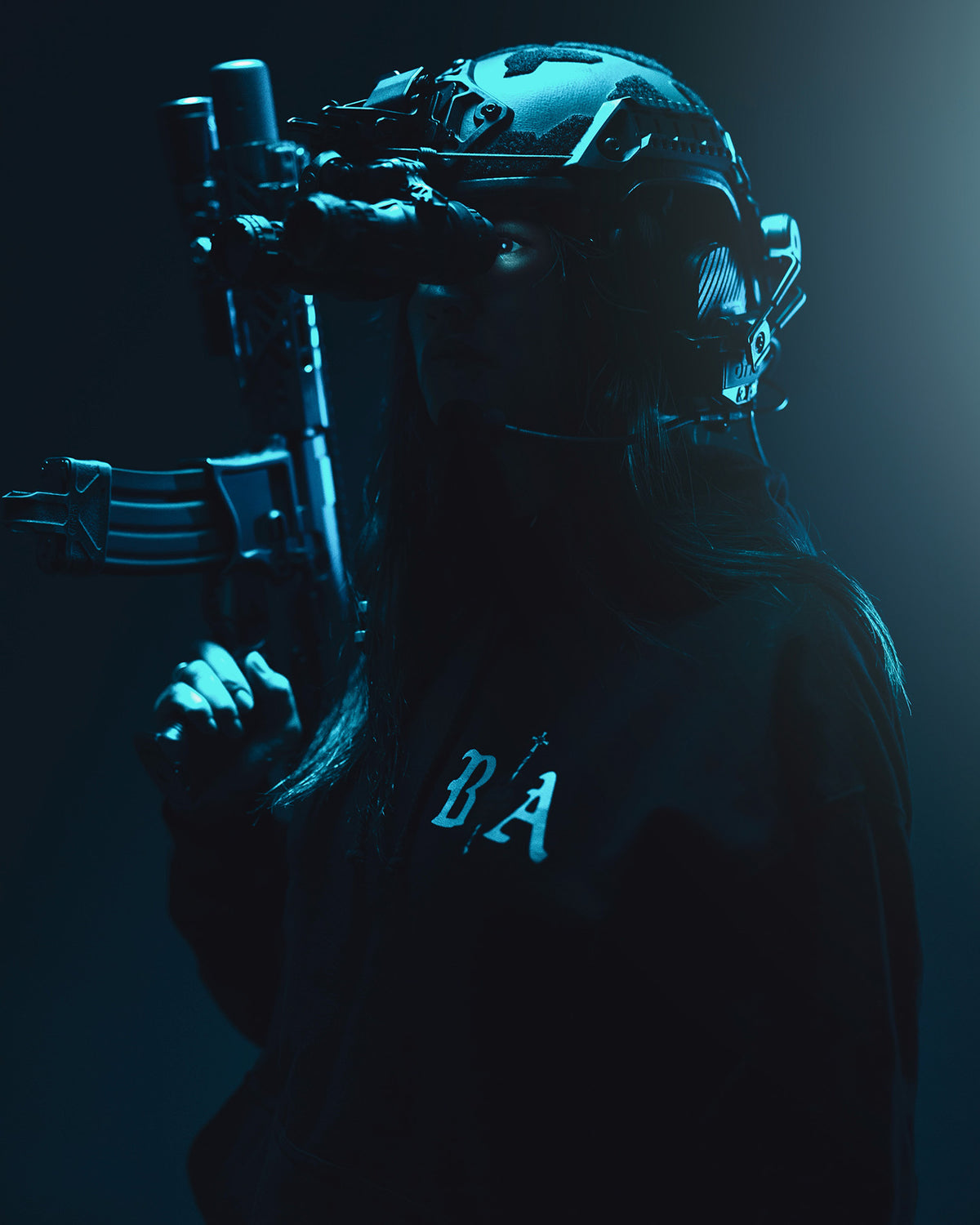 Man in the black Kill Your Demons Hoodie with night vision, lit blue in the dark