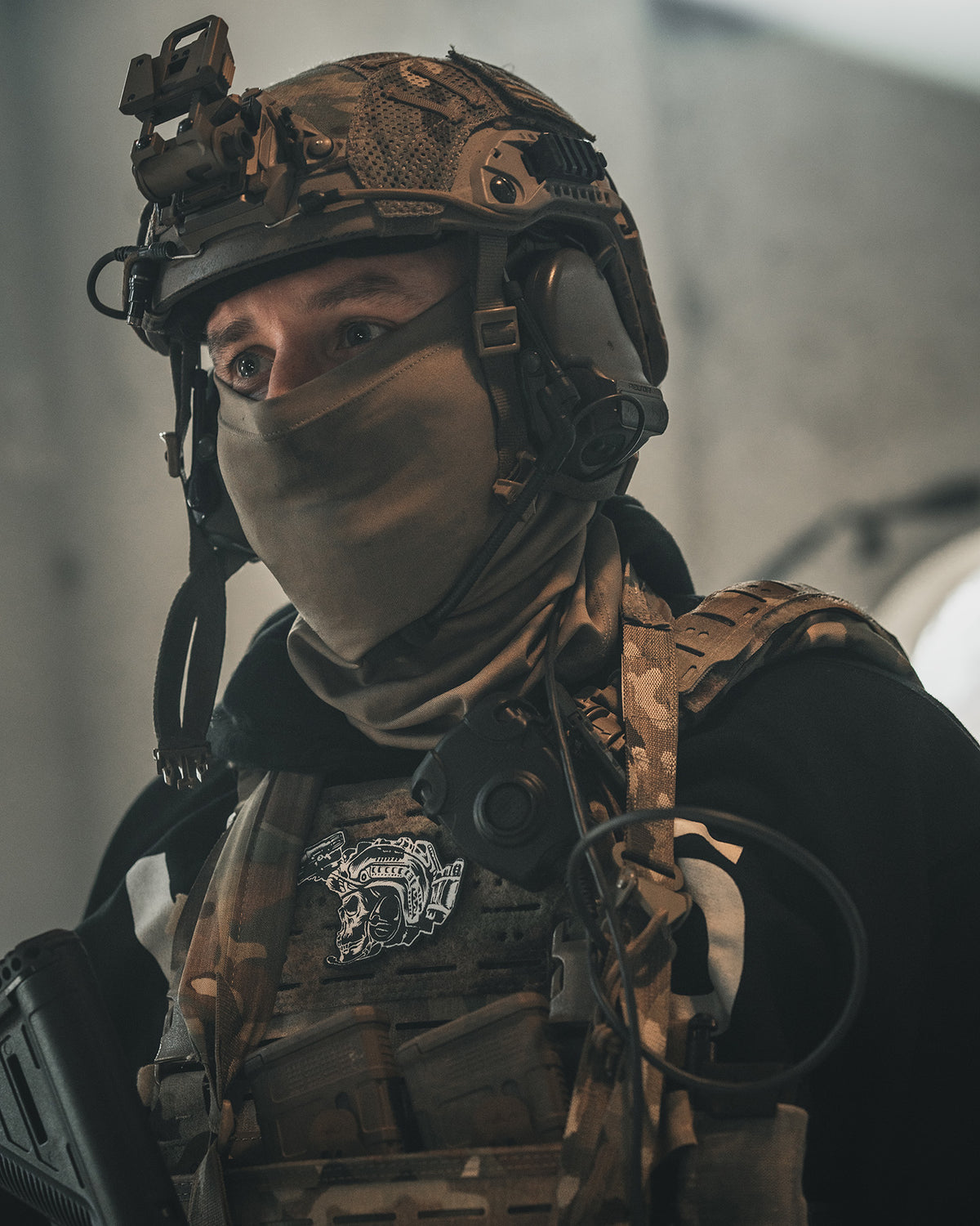 Soldier in full kit with the Team patch on the front of his plate carrier