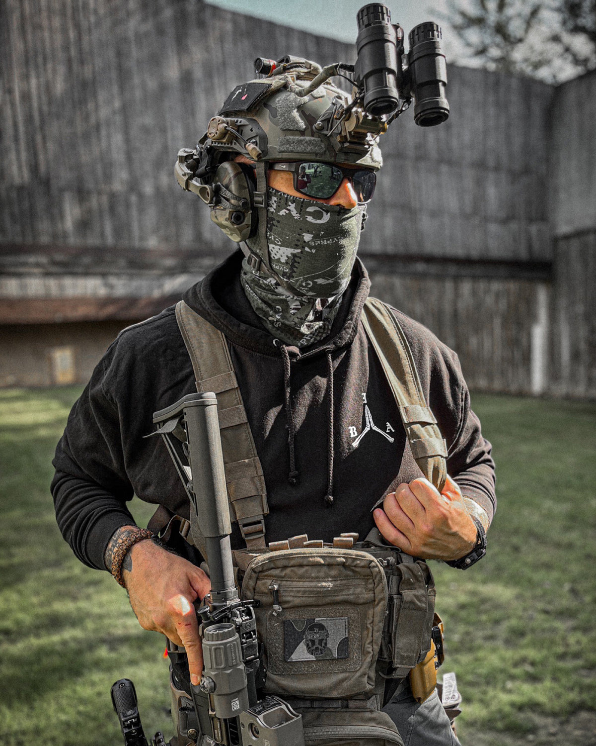 Man with helmet, face mask and chest rig wearing the black Stay Violent Hoodie