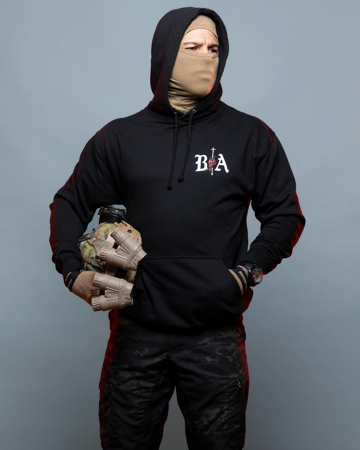 Man in the black Kill Your Demons Hoodie with the hood up, front view with the chest logo