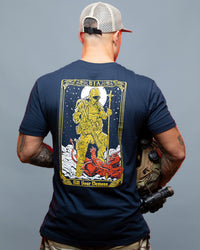 Man wearing a navy blue t-shirt with a graphic design on the back, standing against a gray background. #color_navy