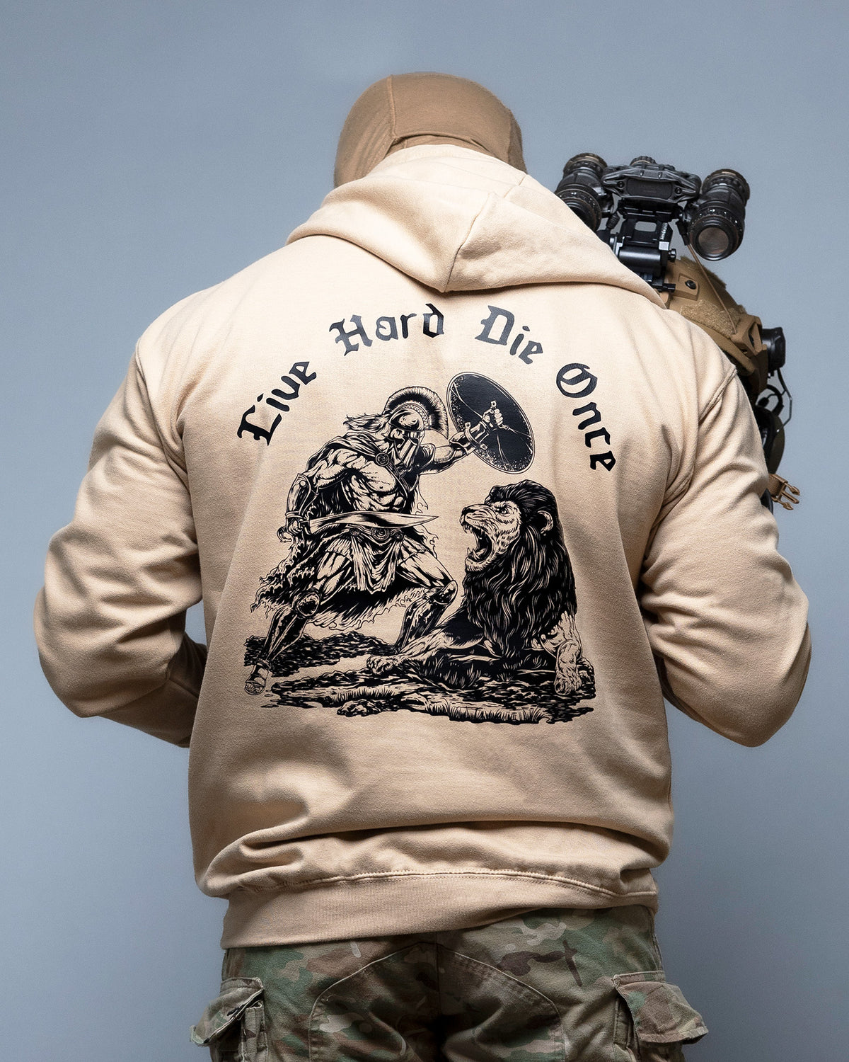 Man from behind in the sand Live Hard Die Once Hoodie with a rifle, large back print