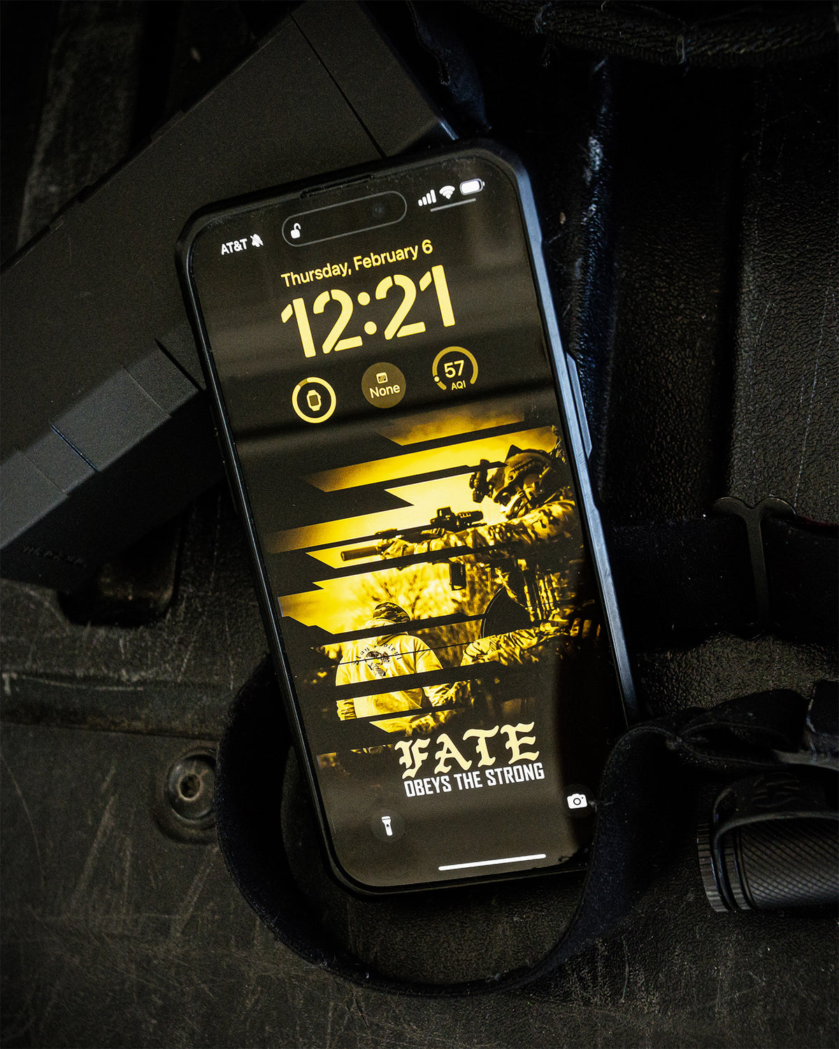 Phone displaying the gold Fate wallpaper from the Discipline collection