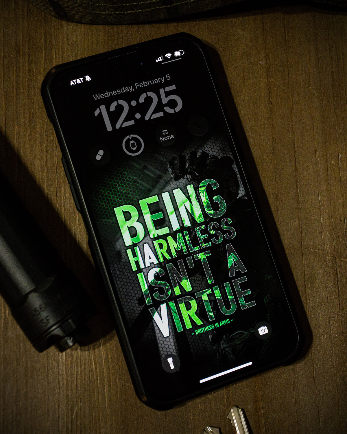 Phone showing the green Being Harmless Isn't A Virtue wallpaper