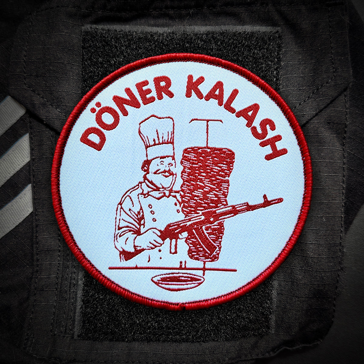 Round Döner Kalash patch in red and white on a black velcro panel