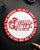 Circular Coin with text and graphics on a dark surface