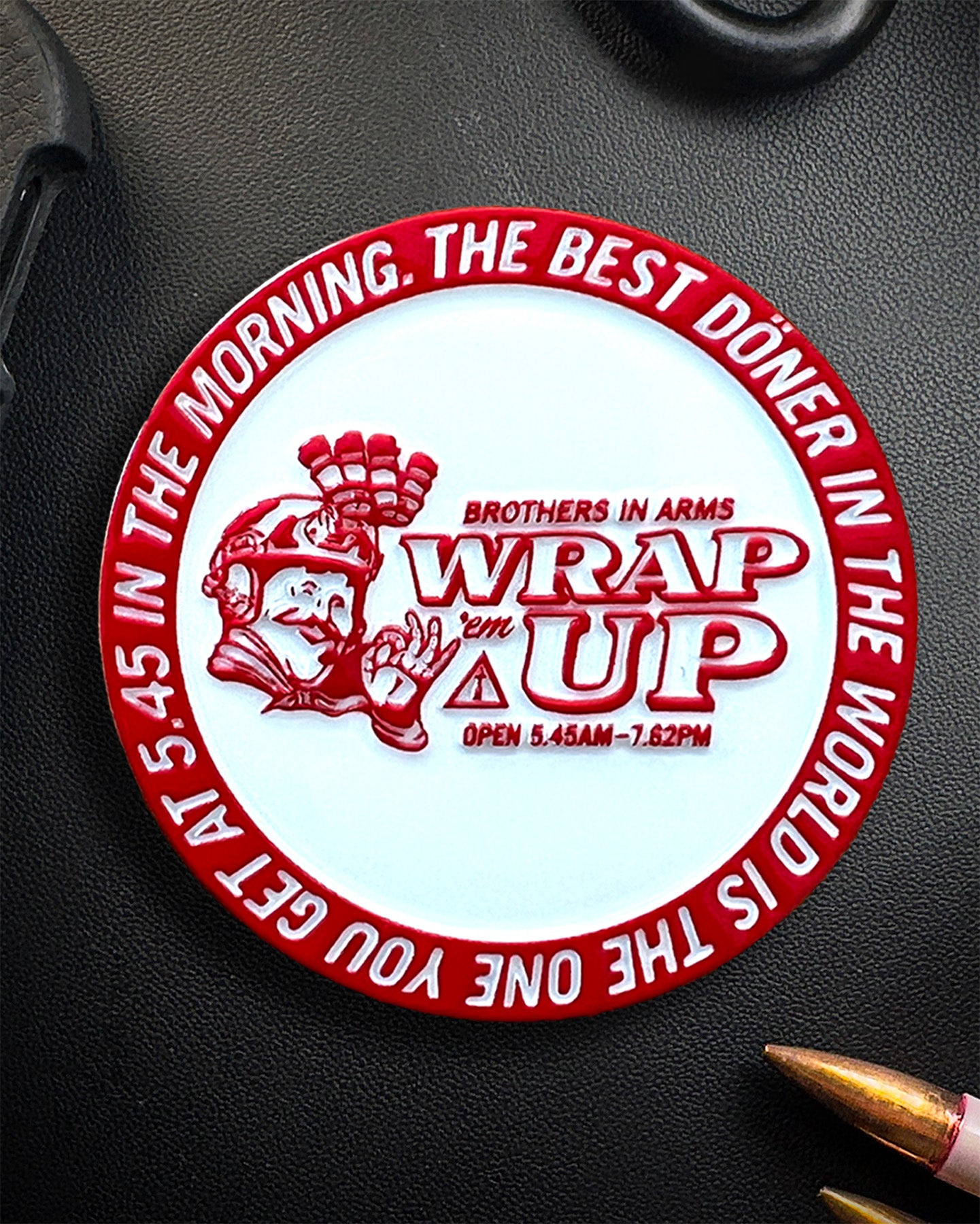 Circular Coin with text and graphics on a dark surface