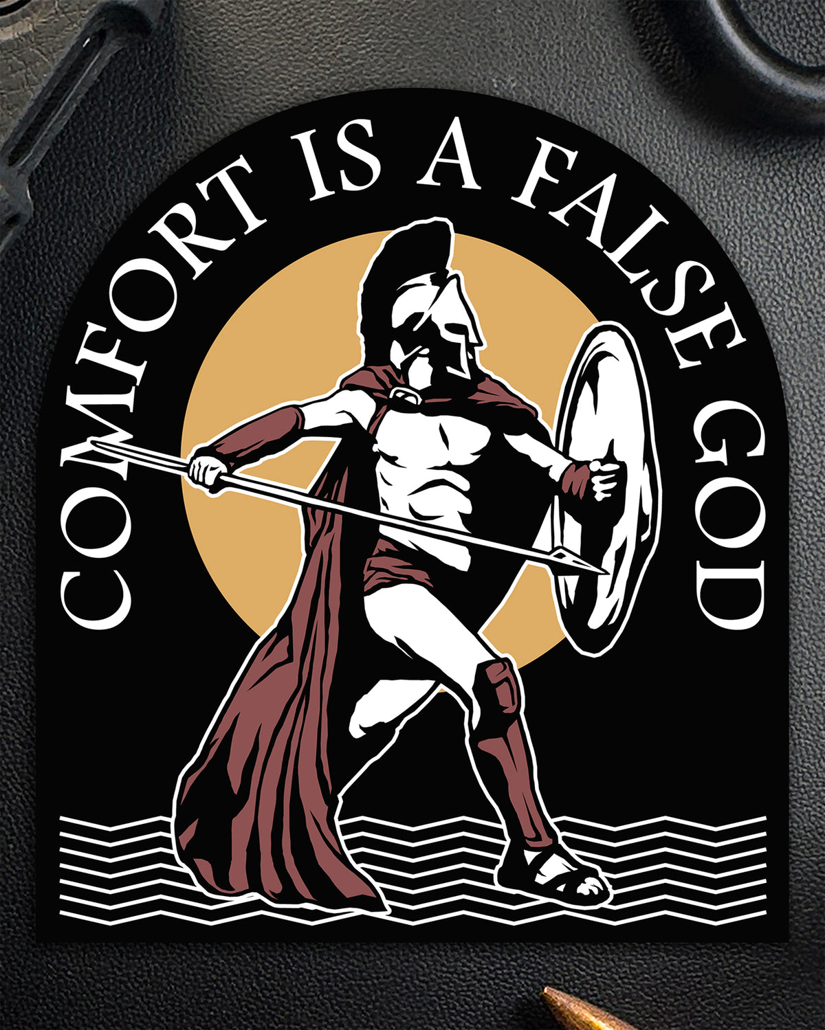 Single Comfort Is A False God sticker showing a Spartan warrior with spear and shield