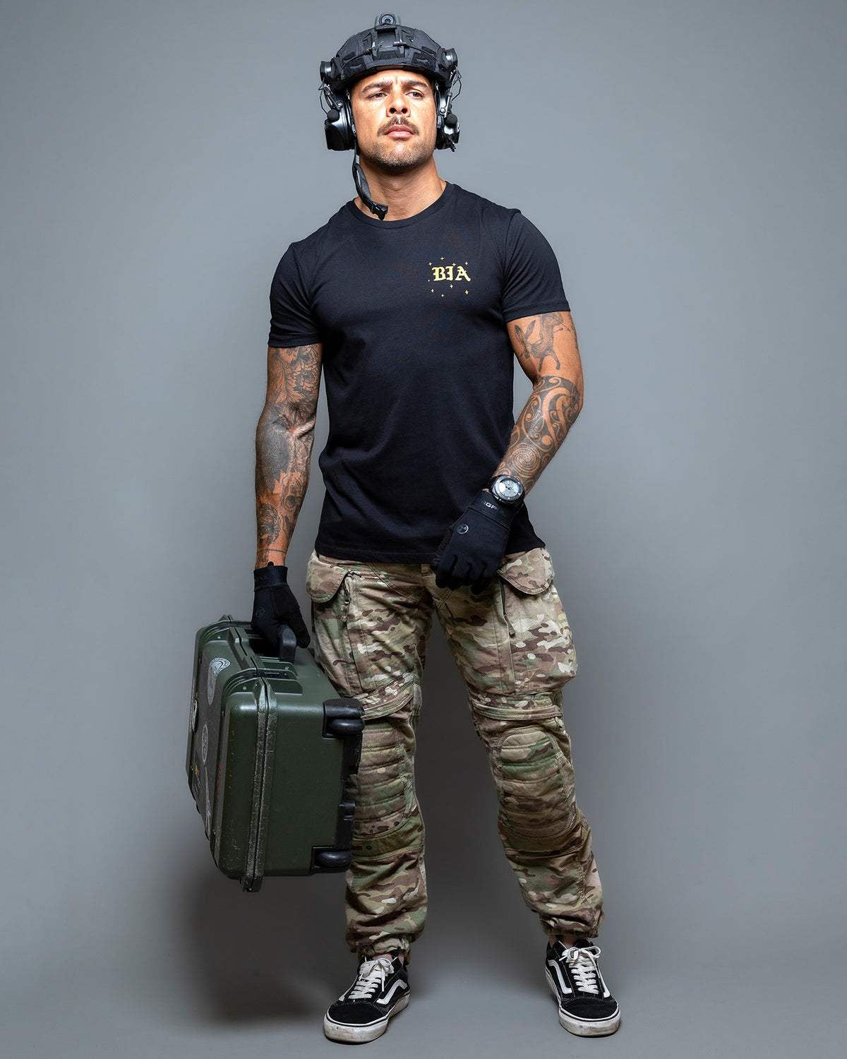 Full-length shot of the black Eyes On The Horizon T-Shirt with camo trousers and an ammo can