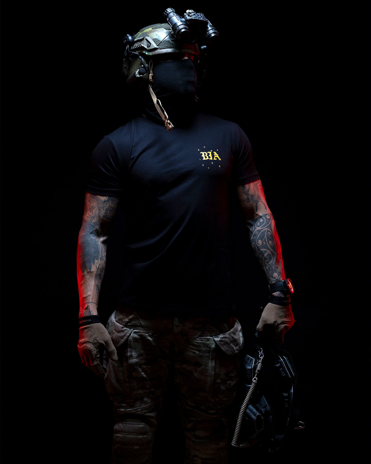 Operator with a helmet wearing the black Eyes On The Horizon T-Shirt against a dark background