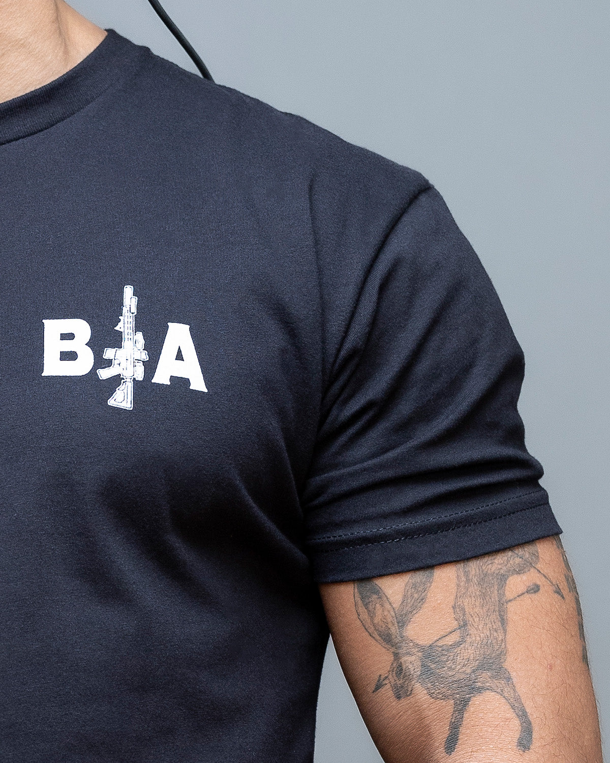 Close-up of the B|A rifle chest logo on the black King of Spades T-Shirt