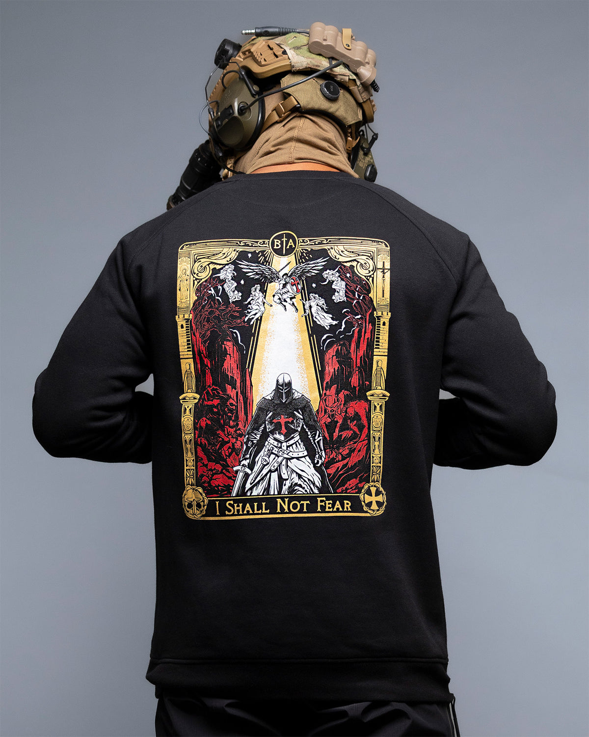 Man from behind with helmet and headset in the black No Fear Crewneck, knight tarot back print