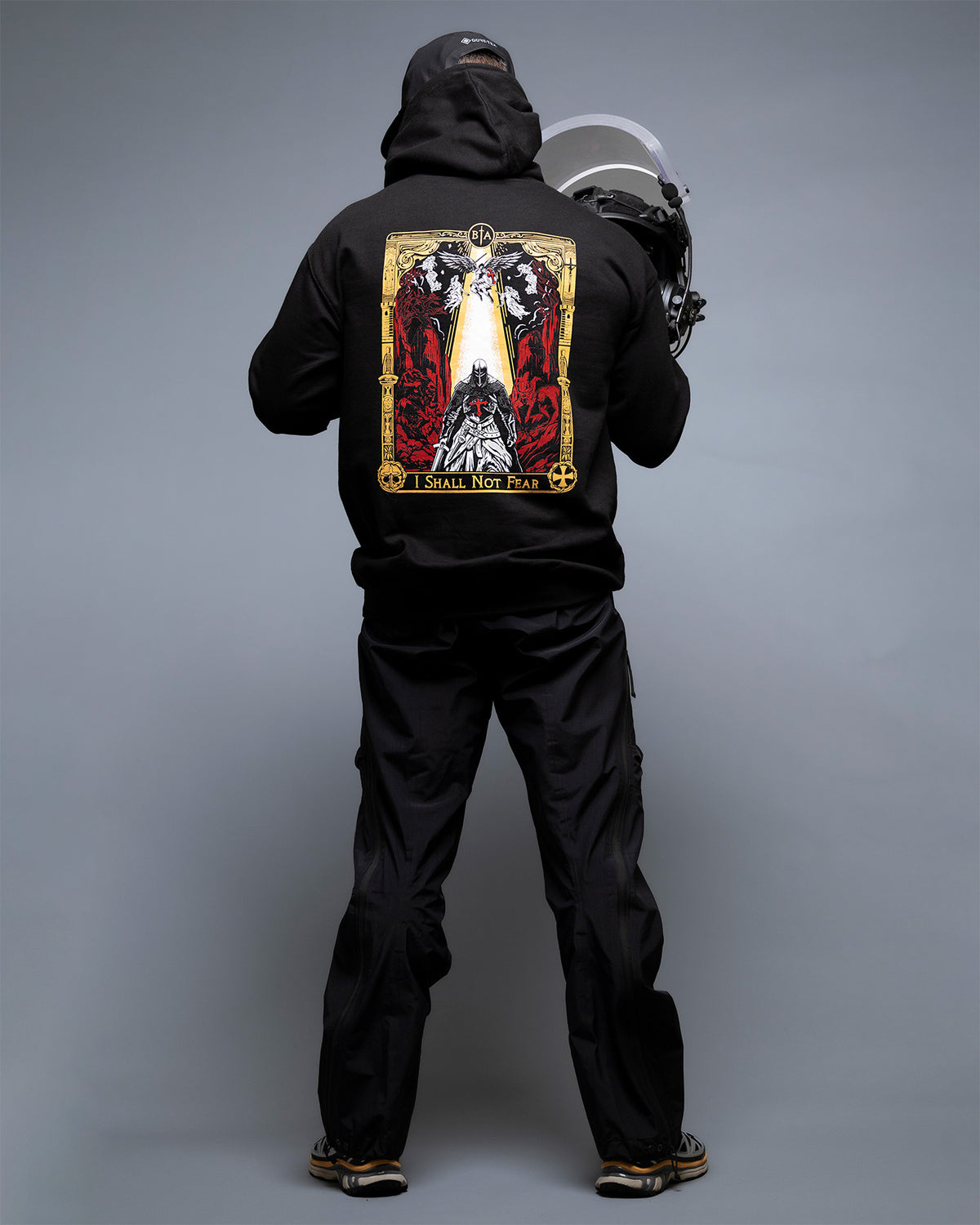 Man from behind at full length in the black No Fear Hoodie with the knight tarot back print