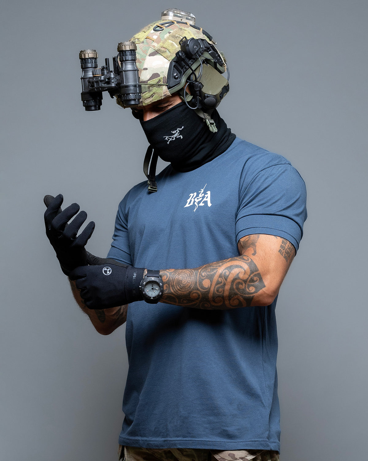 Man with helmet and neck gaiter wearing the indigo St. Michael T-Shirt