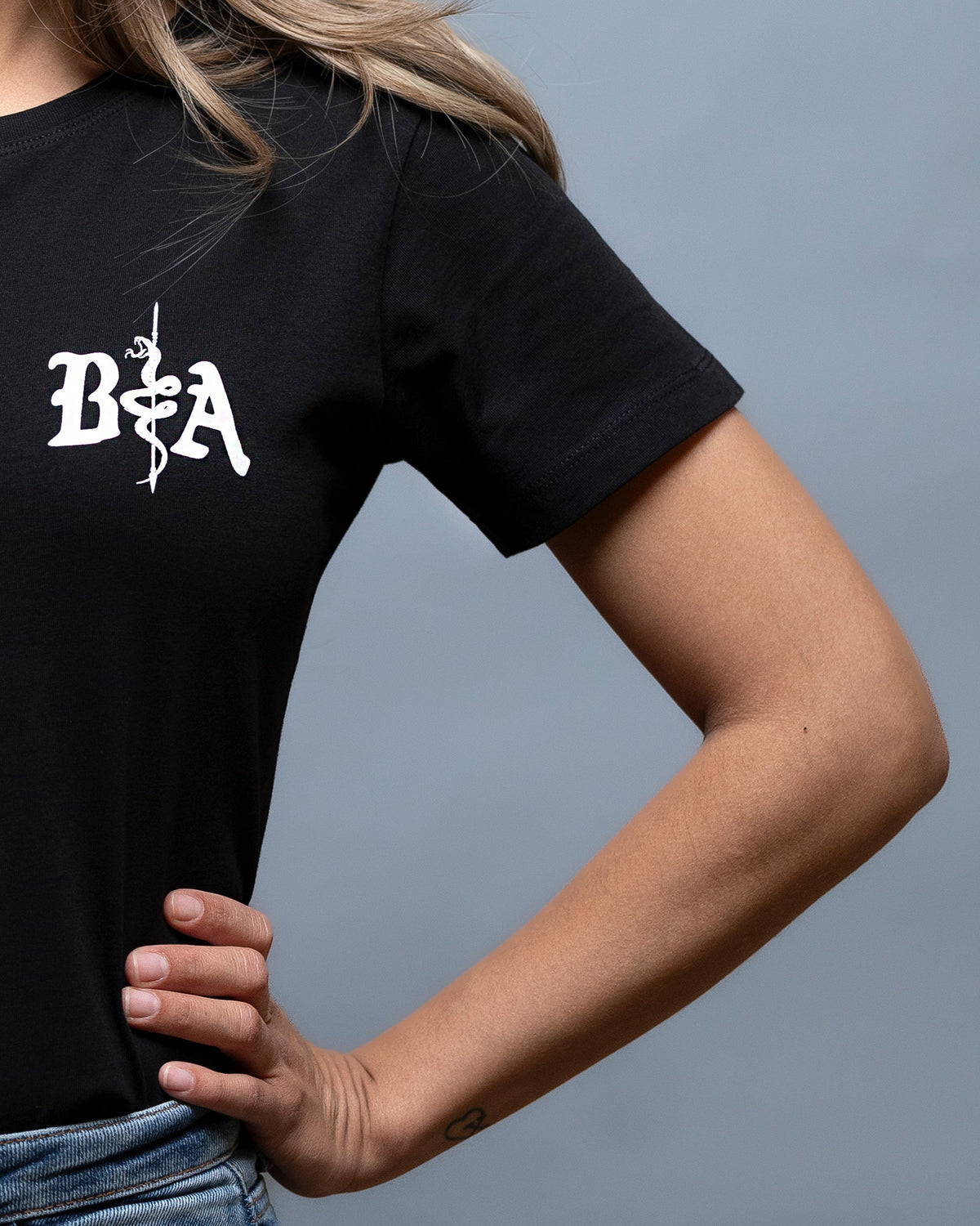 Close-up of the B|A chest logo on the black St. Michael Women's Shirt