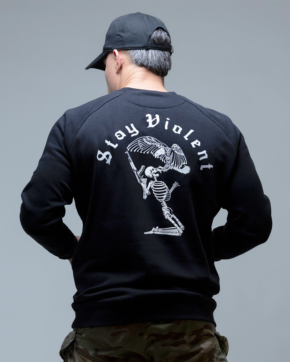Man from behind in the black Stay Violent crewneck showing the back print