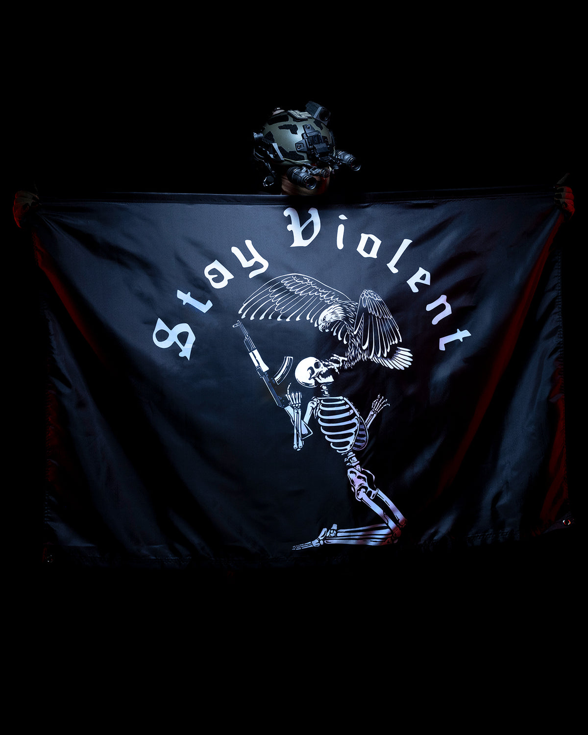 Stay Violent flag lit in red against a dark background
