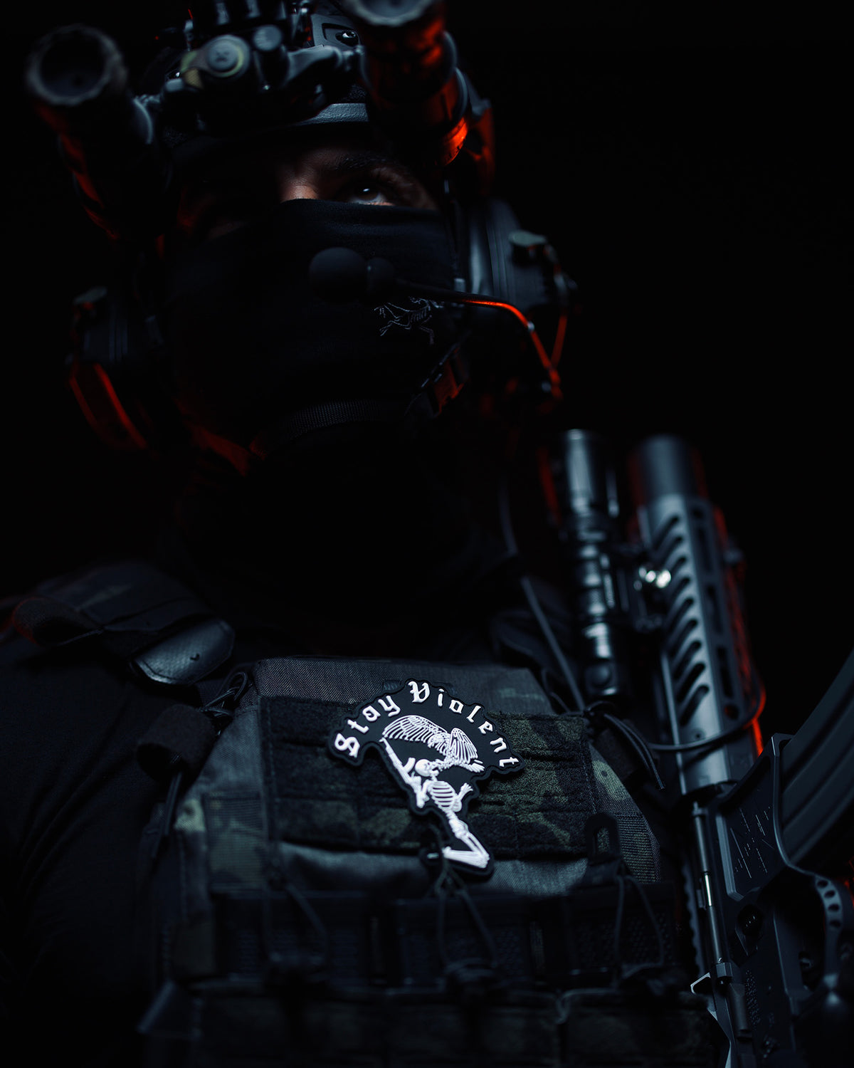 Stay Violent 3D patch on a plate carrier, lit red in the dark