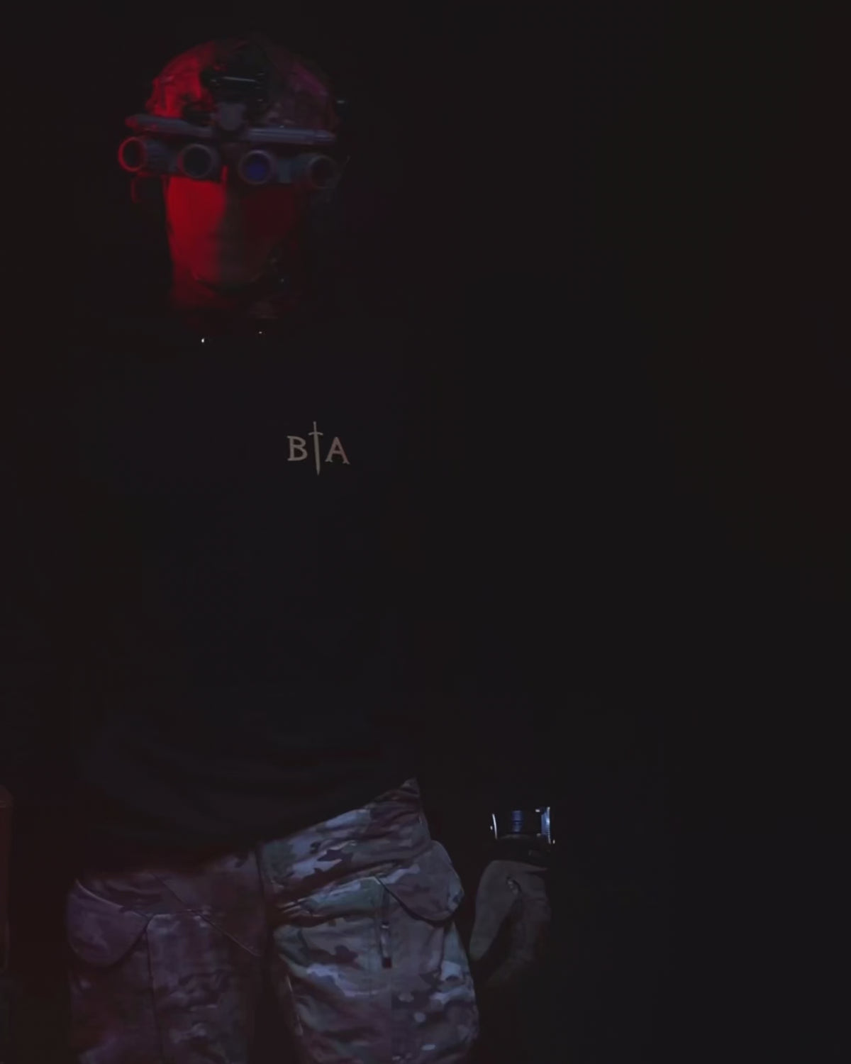 Product video of the black No Fear Hoodie worn in low light with a rifle