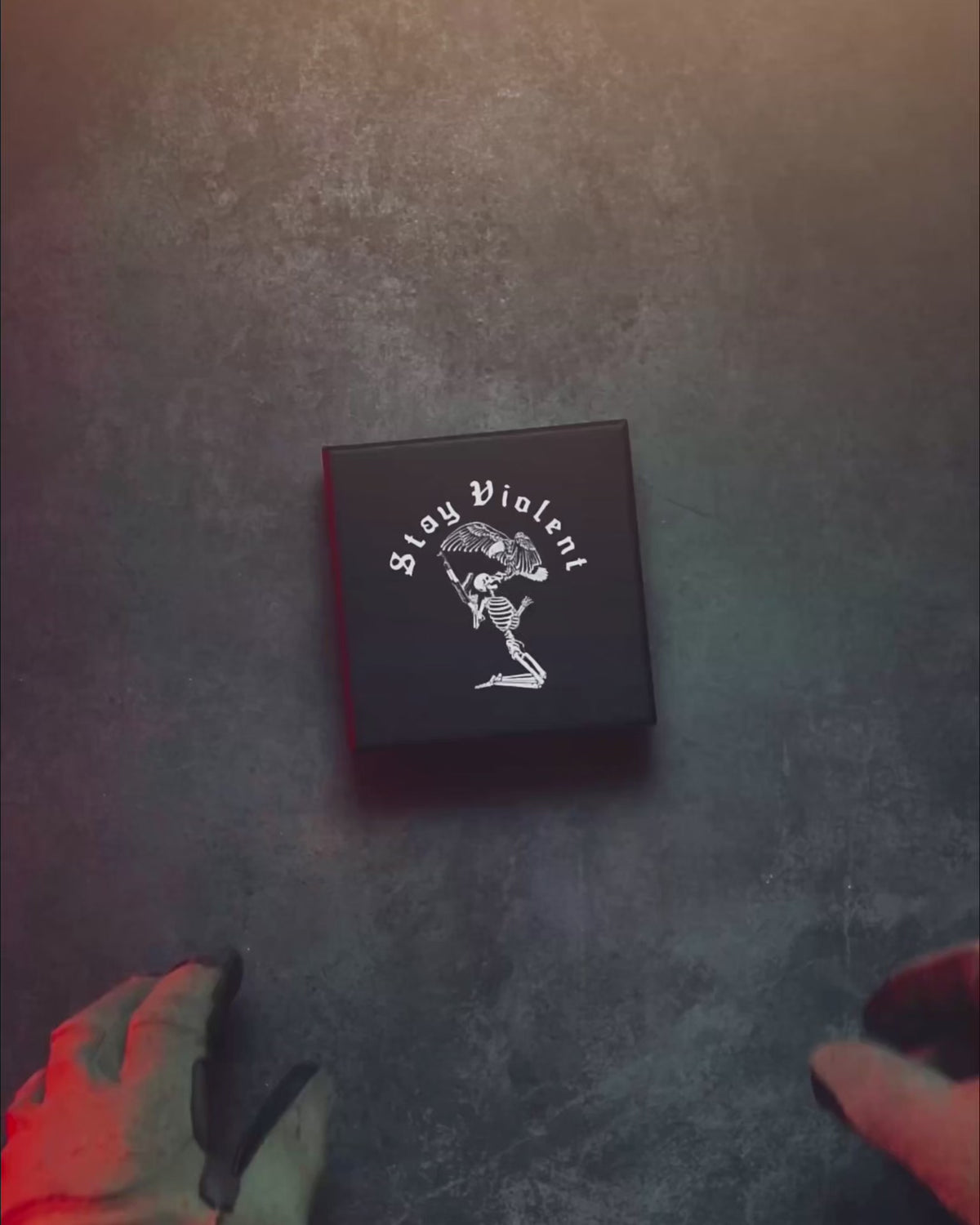Product video of the black Stay Violent Pouch Can with the skeleton motif on the lid