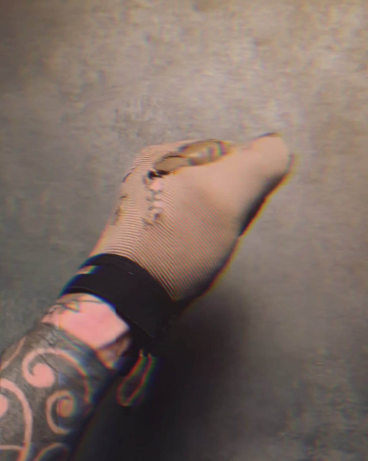 Product video of the Stay Violent coin held in a gloved hand
